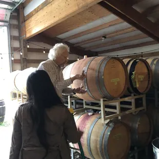 a man and a woman inspecting barrels