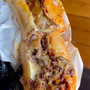 a hand holding a sandwich