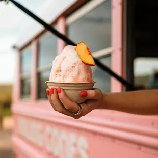 a person holding a bowl of ice cream
