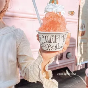 a little girl holding an ice cream cone