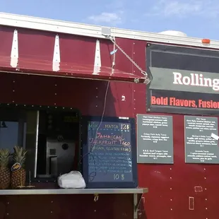 a red food truck with menus