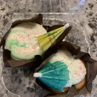 two cupcakes in a plastic container