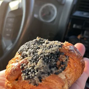 a person holding a pastry in their hand