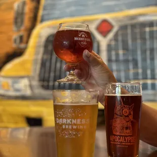 a person holding a glass of beer