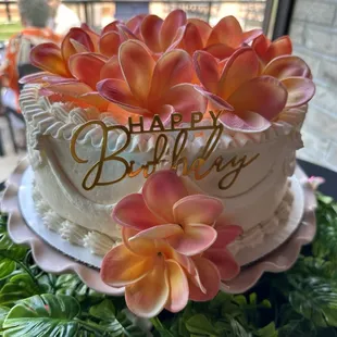 Beautifully white frosted lemon raspberry cake. I added plumerias