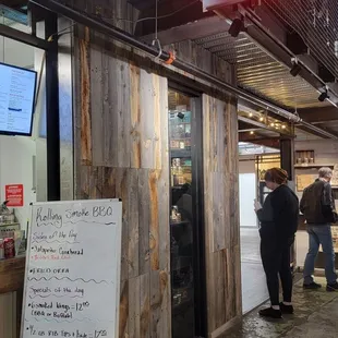 people standing outside of a restaurant