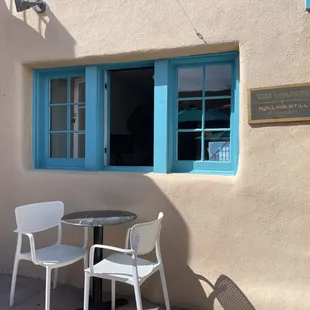 a table and chairs outside a building