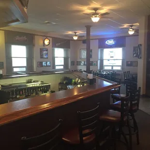 a restaurant with a bar and chairs