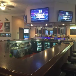 a bar with several televisions on the wall