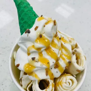 Rolled Salted Caramel Ice Cream with whip cream, caramel and a green come!