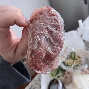 a piece of meat wrapped in plastic