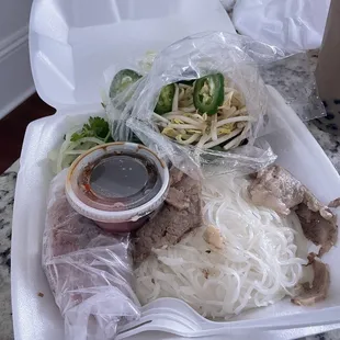 a variety of food items in a styrofoam container