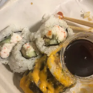 a plate of sushi and chopsticks