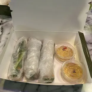 Spring Roll X3 w/ Nem Viet Sausage and Nước Chấm sauce. (rice noodles, cilantro, mint, cucumber, everything seasoning, crunchy things)