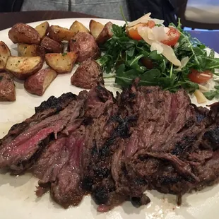 Grilled wagyu skirt steak with arugula and shaved parmigiano, potatoes.