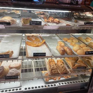 a variety of baked goods in a display case