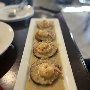 a plate of shrimp and mushrooms