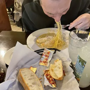 Man in action enjoying his orange roughy with angel hair  Slurp