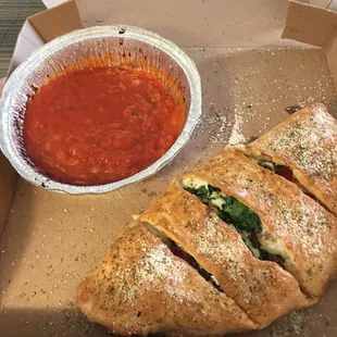 Calzone with pepperoni, sausage, spinach &amp; onions and side marinara sauce (lots).