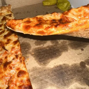 a slice taken out of a pizza box