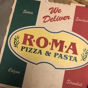 a hand holding a pizza box