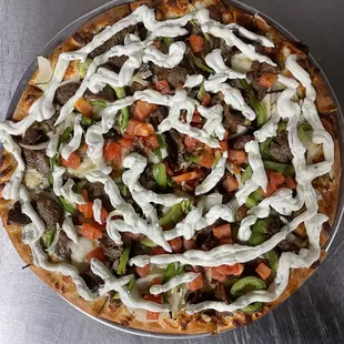 The Gyro Pizza( topped with Gyro meat, green peppers, onions, tomatoes, and tzatziki sauce)