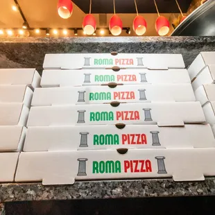 pizza boxes stacked on top of each other