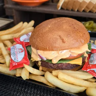 Cheese Burgeperfectly seasoned beef patty topped with cheese, nestled in a soft bun with fresh lettuce, tomato, and a touch of sauce.