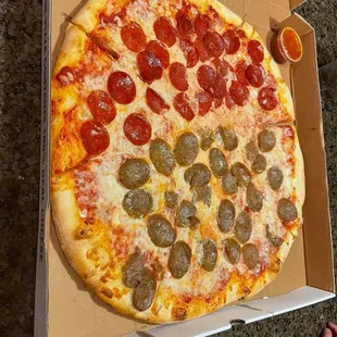 pepperoni and sausage pizza in a box