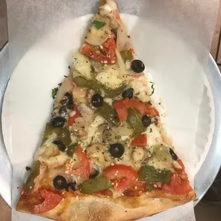 a slice of pizza on a paper plate