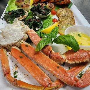 seafood delight sampler of : crab legs, Bada Bing shrimp grilled scallops &amp; oysters romafellar
