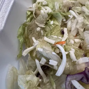 a salad in a styrofoam container
