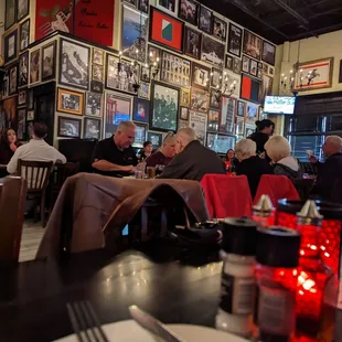 people sitting at tables in a restaurant