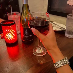 a woman holding a glass of wine