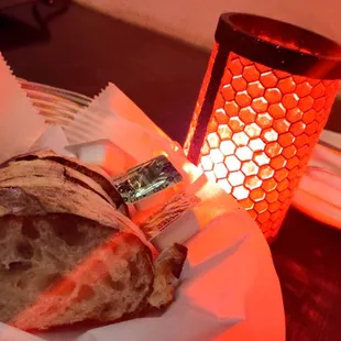 a basket of bread and a candle