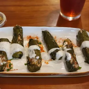 a plate of stuffed poblao peppers