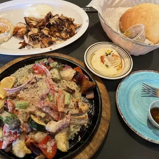 Red fish and chicken plate with humus and pita bread