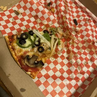 a slice of pizza in a box