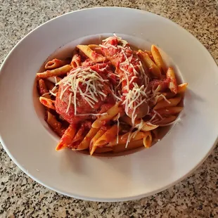 One sausage and one meatball with penne red sauce.
