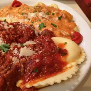 1/2 ravioli with meat sauce and 1/2 tortellini with pink sauce
