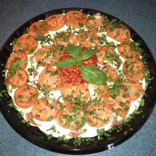 a pizza with tomatoes and basil