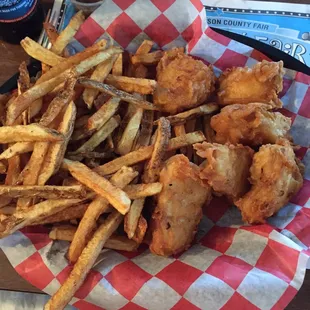 a basket of fried fish and fries