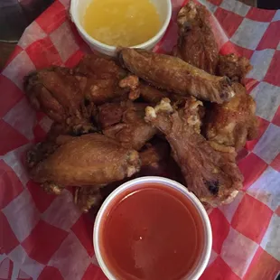 a basket of chicken wings and dipping sauce