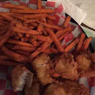 a basket of fried fish and fries