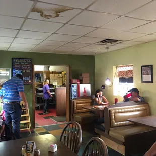 people sitting at tables in a restaurant