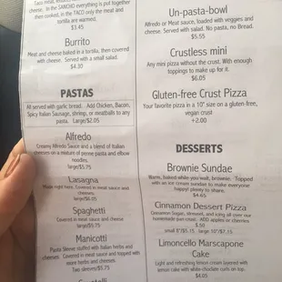 a hand holding a menu