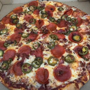 Pepperoni, bacon and jalapeño pizza. Thin crust.