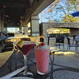 two drinks on a table outside