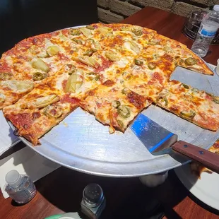 Pizza with pepperoni,garlic,Canadian bacon,jalapeños, and artichoke.