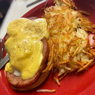 a red plate with a sandwich and french fries